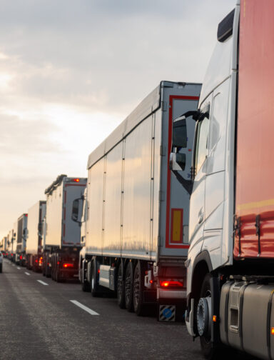 Queue of Trucks on Ukraine-Poland Border traffic jam at Sunset During Protest Roadblock. Business agricultural Logistics blockade action. Cargo lorry semi-trailers stuck.